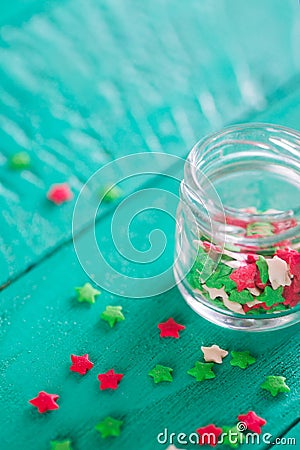 Transparent open glass jar with colorful confectionery powder in Stock Photo