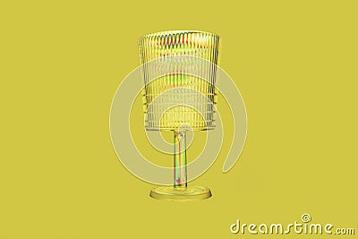 Transparent plastic glass, rainbow colored by photoelasticity isolated on yellow background Stock Photo