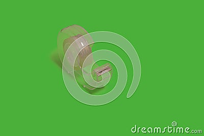 sellotape dispenser isolated on a green background. office accessories Stock Photo