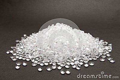 Transparent Polyethylene granules on dark .HDPE Plastic pellets. Plastic Raw material . IDPE. Stock Photo