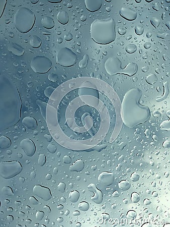 Transparent rain drops on the glass with the dark cloudy sky in Stock Photo