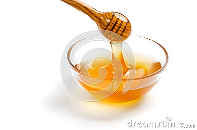 Transparent saucer with honey. Honey flows from a spoon into a plate. White isolated background Stock Photo
