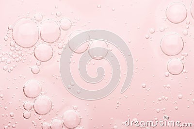 Transparent texture of moisturizing serum on a pink background. Gel water lotion for skincare. Cosmetic liquid beauty product with Stock Photo