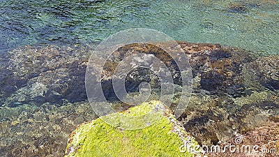 Transparent warm water all year round on the rocky Algerian coast Stock Photo