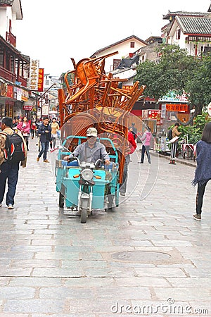 Transport of stacked chairs in West Street,Yangshuo, China Editorial Stock Photo