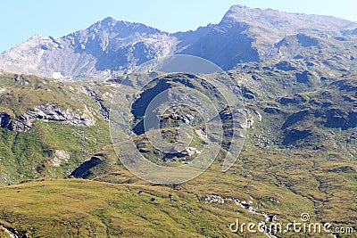 Transport helicopter flying with supplies and mountain panorama, Hohe Tauern Alps, Austria Stock Photo