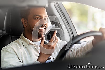 man driving car and recording voice by smartphone Stock Photo