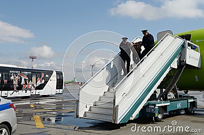 Transport police remove aviation rowdy from the plane at the airport Editorial Stock Photo