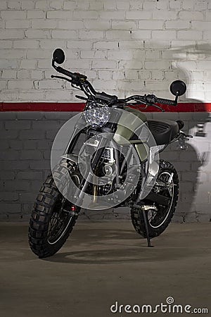Transport racing motorcycle green on brick wall background Stock Photo