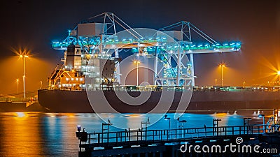 Transport Ship in harbor at night Stock Photo