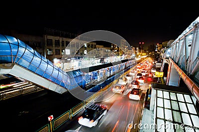 Transport traffic with lights of cars on the busy street of night urban city Editorial Stock Photo