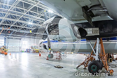 Transport turboprop airplane in the hangar. Aircraft under maintenance Editorial Stock Photo