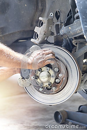 Hand mechanic repair brake disc Stock Photo