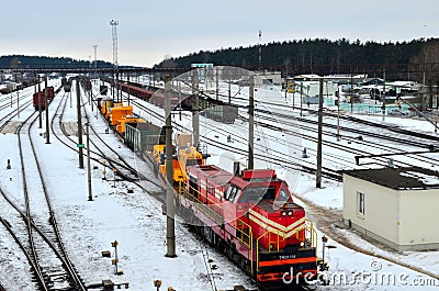 Transportation of dump trucks Belaz by rail. Heavy yellow mining truck disassembled on a railway platform. Stock Photo