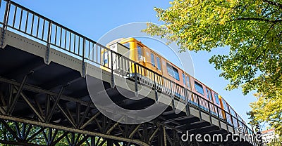 Transportation means. Yellow electric train, Berlin, Kreuzberg east side, Germany. Under view Stock Photo