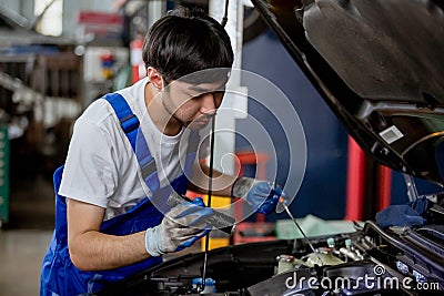 Transportation repair service concept, Repairman auto mechanic using flashlight to check for damage inside engine. man worker Stock Photo