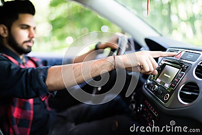 Transportation and vehicle concept - Indian man pressing red triangle car hazard warning button Stock Photo