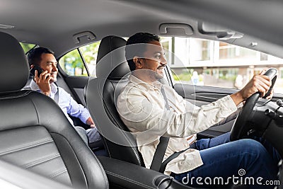 male passenger calling on smartphone in taxi car Stock Photo