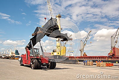 Transshipment terminal for loading steel products to sea vessels using shore cranes and special equipment in Port Pecem, Brazil, Editorial Stock Photo