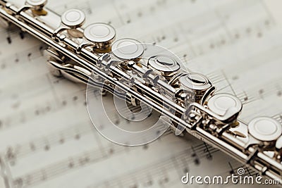 Transverse flute on music sheet Stock Photo