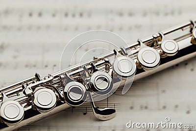 Transverse flute on music sheet Stock Photo