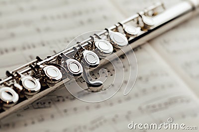 Transverse flute on music sheet Stock Photo