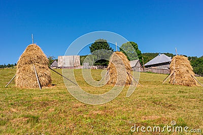 Transylvanian mountains with typical bales on the hillside, Bihar mountains, Carpathian mountains Stock Photo