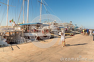 Passengers take the ferry to go to the Egadi islands in the port of Trapani, Sicily Editorial Stock Photo