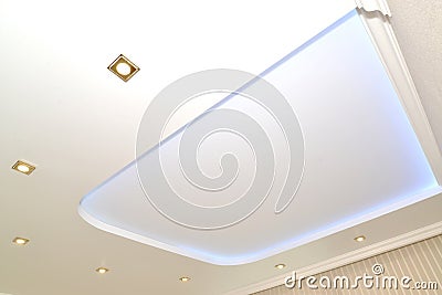Trapezoid design and dot lamps on an opaque stretch ceiling Stock Photo