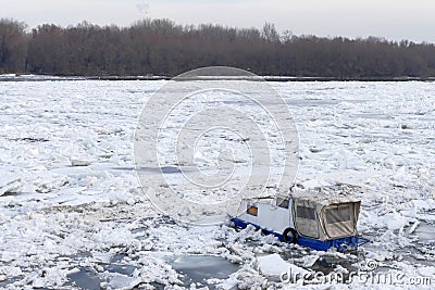 Trapped boat into the frozen Danube river Editorial Stock Photo