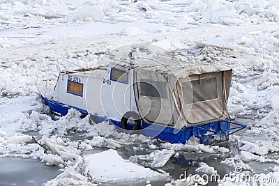 Trapped boat into the frozen Danube river Editorial Stock Photo