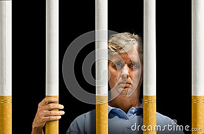 Trapped by cigarettes nicotine addiction prison Stock Photo