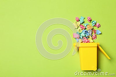 Trash bin and different garbage on color background, top view with space for text. Waste recycling concept Stock Photo