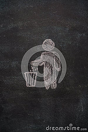 Trash bin with human symbol on black chalkboard Stock Photo