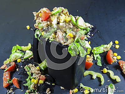 Trash can filled with wasted food Stock Photo