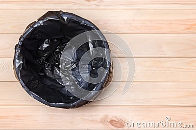 Empty Bin on Wooden Background. Trash Can Top View. Garbage Basket. Rubbish Black Bag in a Trash Can. Empty Rubbish Bin. Waste Can Stock Photo