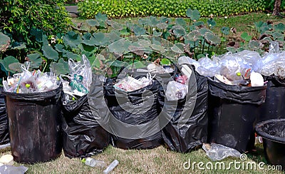 Trash can, waste bin, trash can in the park, plastic garbage waste, rubbish, pollution from waste Stock Photo