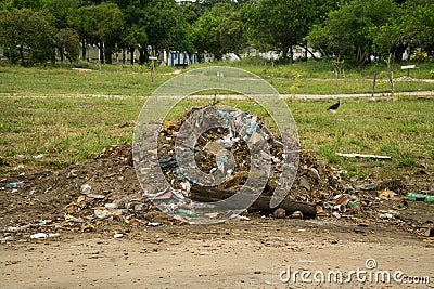 Trash and debris piled at an entrance to a park Editorial Stock Photo