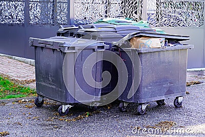 Trash garbage full container grey in city street Stock Photo