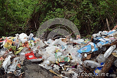 Trash garbage piles thrown along mountain side by uncaring and irresponsible neighborhood Editorial Stock Photo