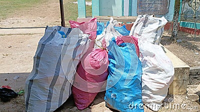 trash packed in large sacks and ready to be transported by garbage trucks Editorial Stock Photo