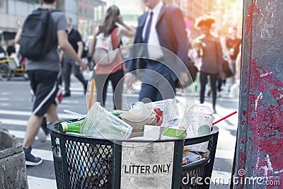 Trash waste bin on new york city street with people and copyspace. Stock Photo