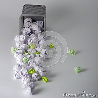 A trashcan full of crumpled paper on white background close up Stock Photo