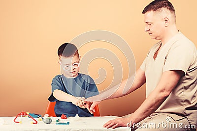 Trauma and injurie. Medicine concept. Kid little doctor sit table medical tools. Health care. Medical examination. Boy Stock Photo