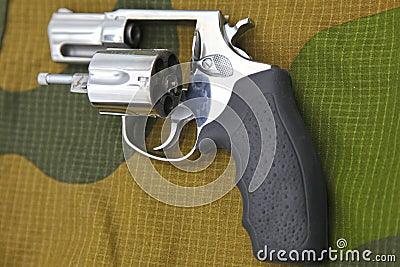 Traumatic Taurus revolver on the background of camouflage Editorial Stock Photo