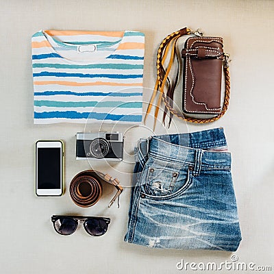 Travel accessories. Sweaters, jeans, cellphone, belts, wallets, Stock Photo