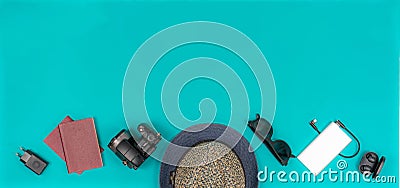 Travel accessories on the turquoise background. Place: center botton. Stock Photo