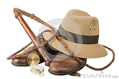 Travel and adventure concept. Vintage brown shoes with fedora hat, bullwhip and compass isolated Stock Photo