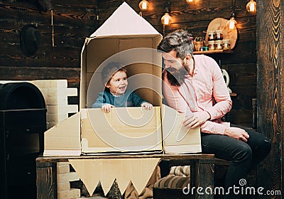 Travel and adventure. Father and small boy in paper rocket. Family and childhood. Earth day concept. father day. Dream Stock Photo