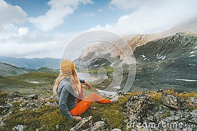 Travel adventure in mountains globetrotter woman sitting alone outdoor active vacations healthy lifestyle Stock Photo